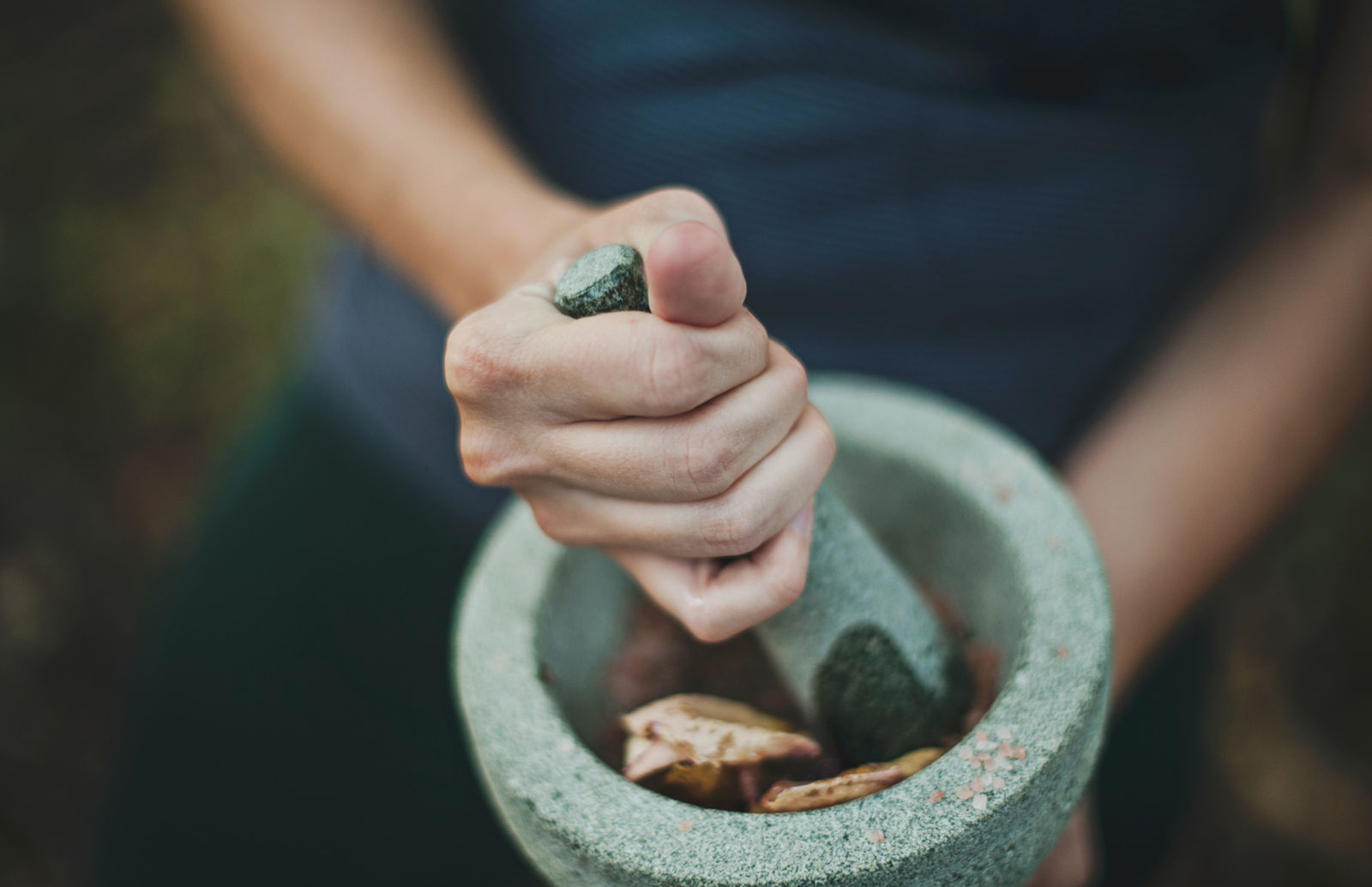 Ayurvedic herbs being prepared in a mortar